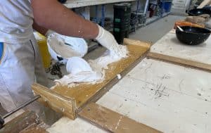 image of plaster craftsman spinning a fretwork spindle